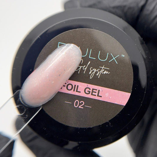 Foil gel container with a gloved hand applying gel to a brush