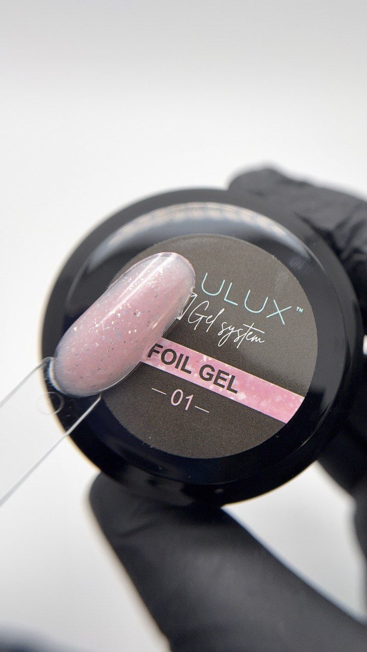 Foil gel being applied with a brush, featuring 'ULUX' branding.